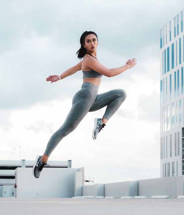 Woman demonstrating a flexibility exercise with focus and grace.